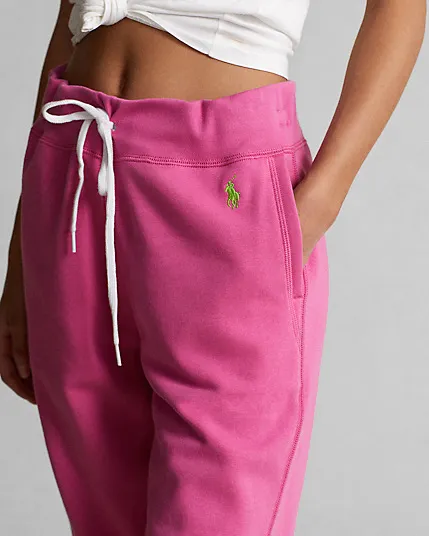 Jogger fucsia in felpa di misto cotone stretch con logo verde acido ricamato sul fianco